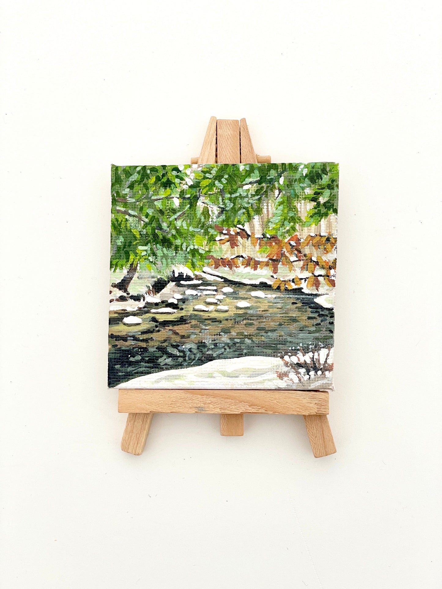 Mini art - acrylic painting of a forest river with beech leaves along the edge