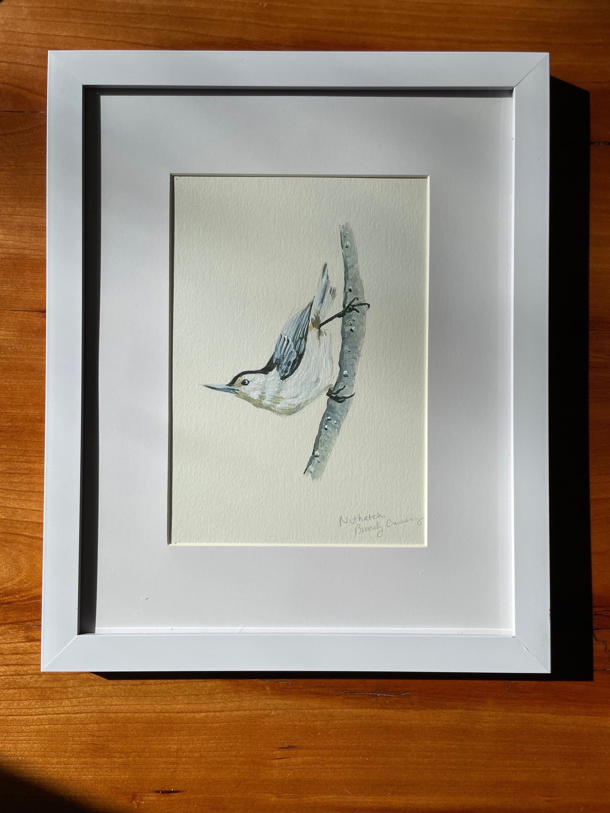 Framed acrylic painting of a nuthatch by brandy cressey for florence farmstead in maine.