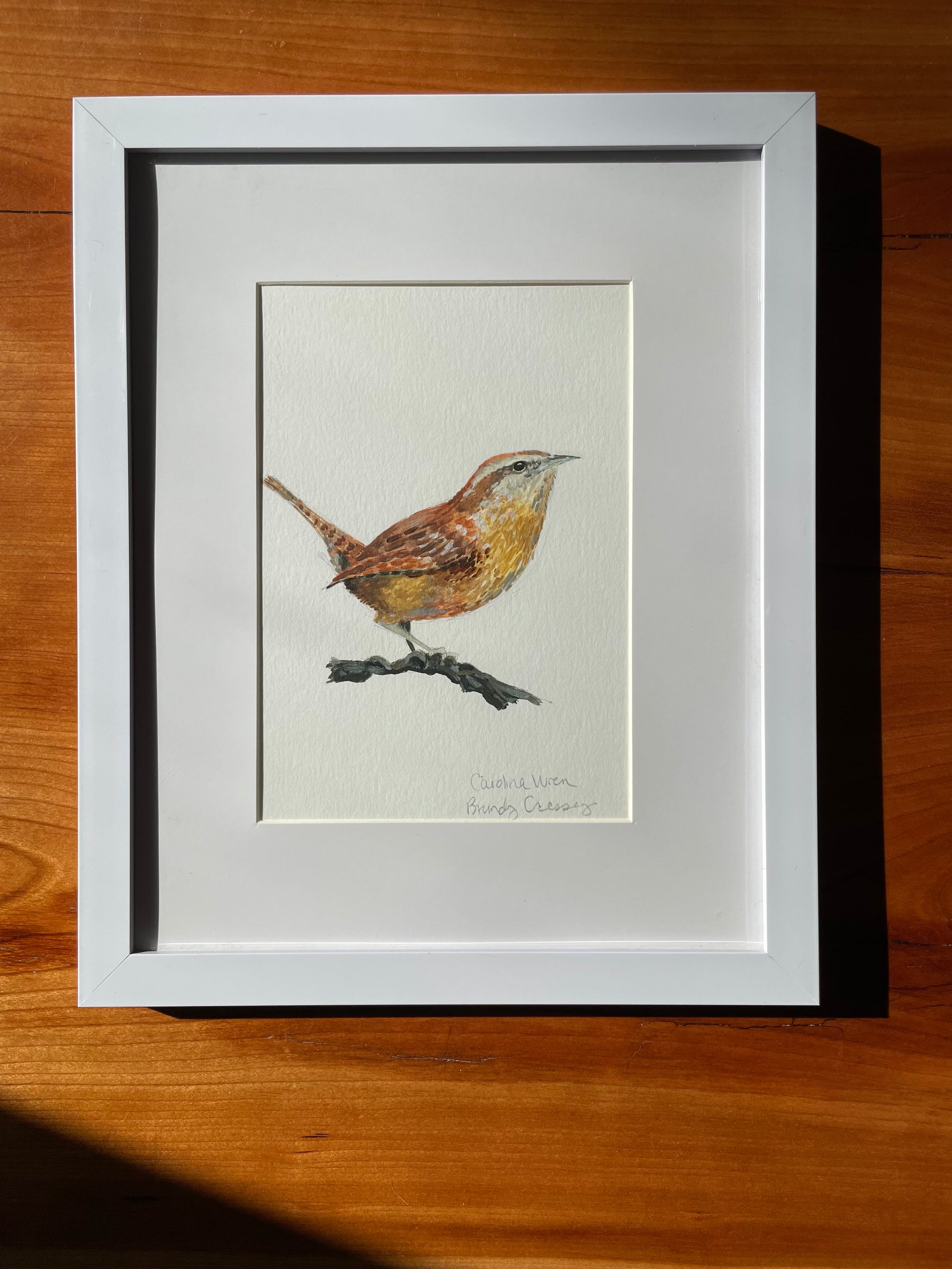 framed acrylic painting of a carolina wren by brandy cressey for florence farmstead in maine.